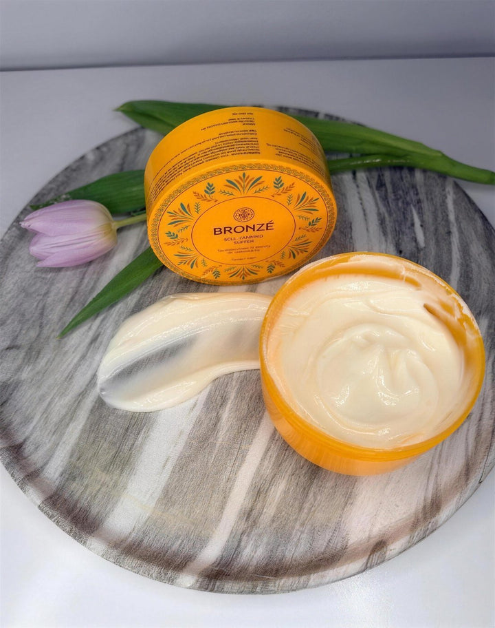 BRONZÉ Self-Tanning Butter jar with a swatch of the butter (product photo)