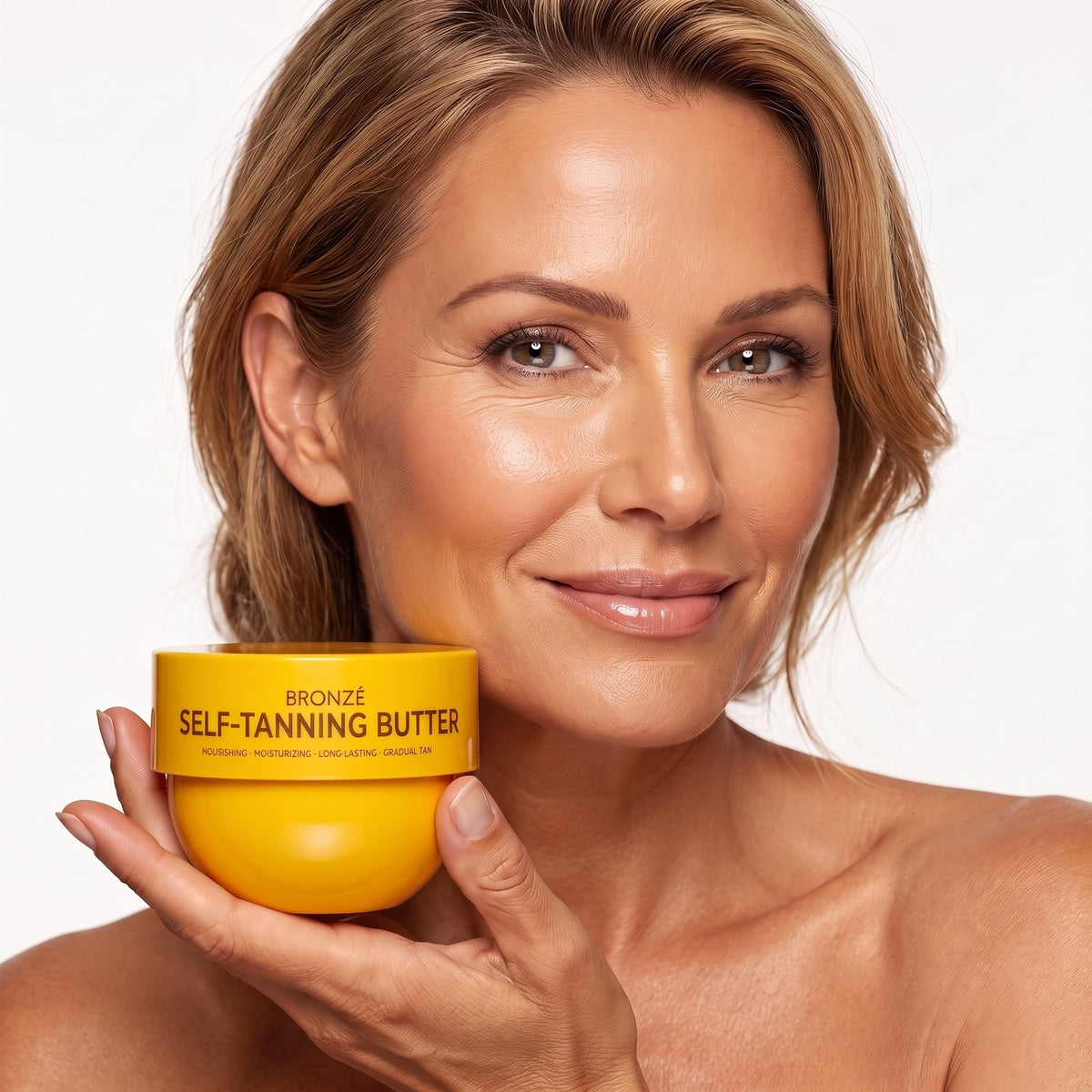 Woman holding a jar of BRONZÉ Self-Tanning Butter